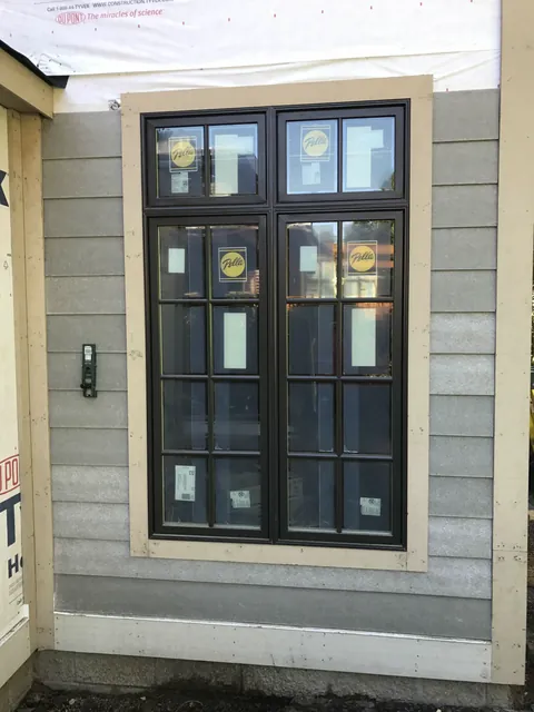 Dark window with unfinished trim during installation