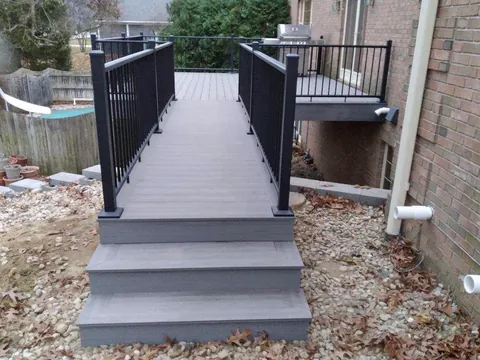 Gray deck walkway with black railings