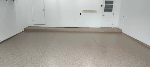 Light speckled floor beside a white wall
