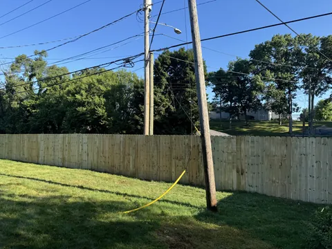 Long wood privacy fence along a yard