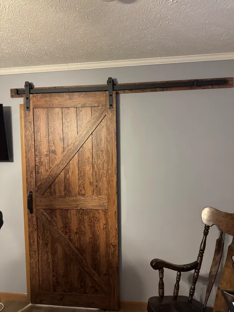 Sliding wood interior door on a dark track