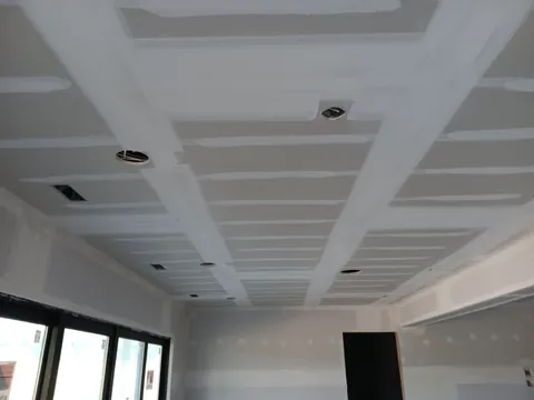 Taped drywall joints during ceiling work