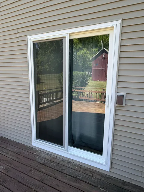White sliding patio door viewed from a deck