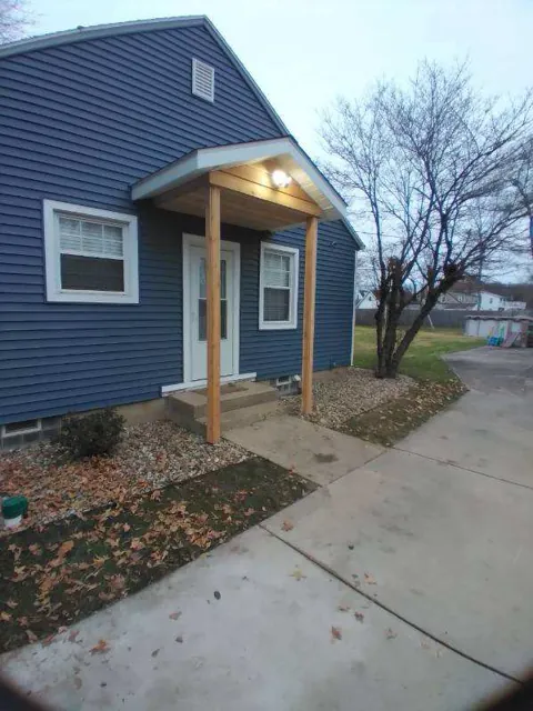 Blue siding and a covered front entry