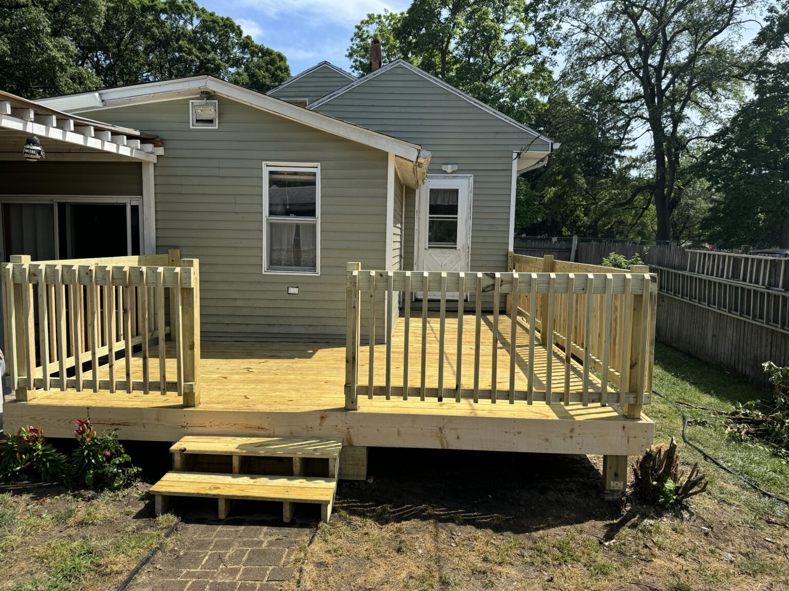 Wood deck and covered porch beside the house