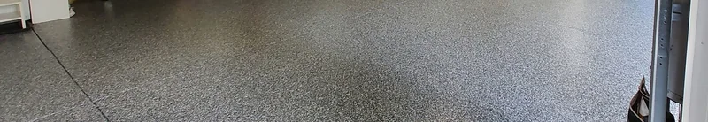 Dark speckled garage floor, cropped to show the surface