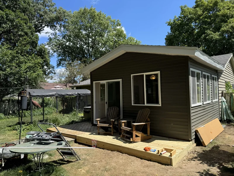 Room exterior with siding, windows and a wood deck